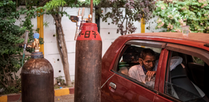 A COVID-19 patient is treated with free oxygen at a makeshift clinic outside a Sikh house of worship on May 2 in New Delhi. 